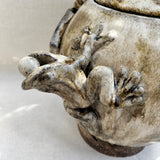 “Grão a grão enche a galinha o papo” — "Grain by grain, the hen fills her crop.”