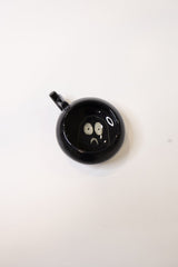 Black_ceramic_cup_with_hidden_design