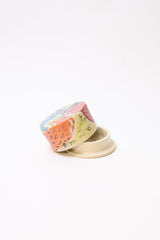 A small colorfully patterned butter dish
